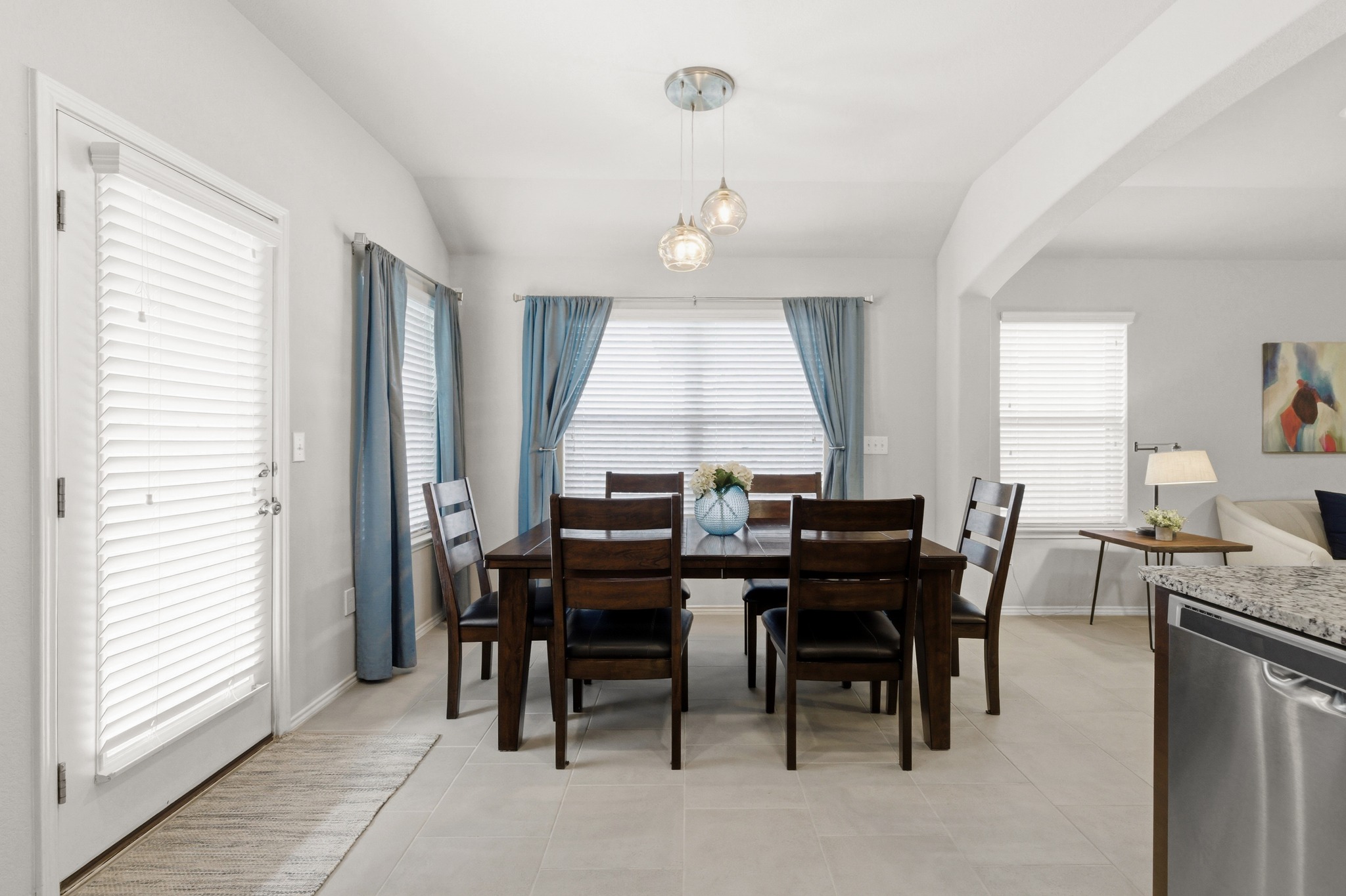 219 Noddy Road Buda, TX 78610 - Photo 18 of 31 Dining area with vaulted ceiling, light tile patterned flooring, and arched walkways