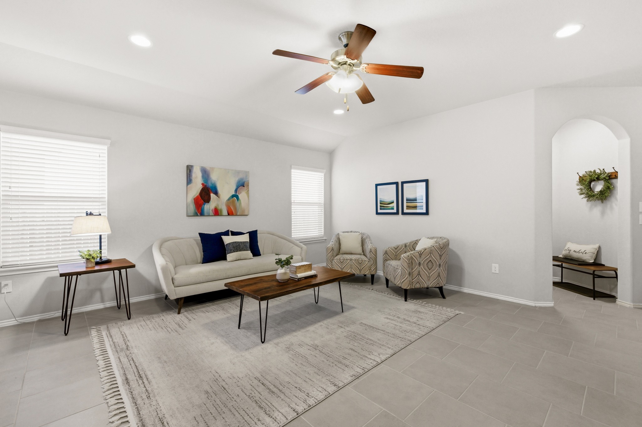 219 Noddy Road Buda, TX 78610 - Photo 10 of 31 Living area with recessed lighting, ceiling fan, lofted ceiling, and arched walkways