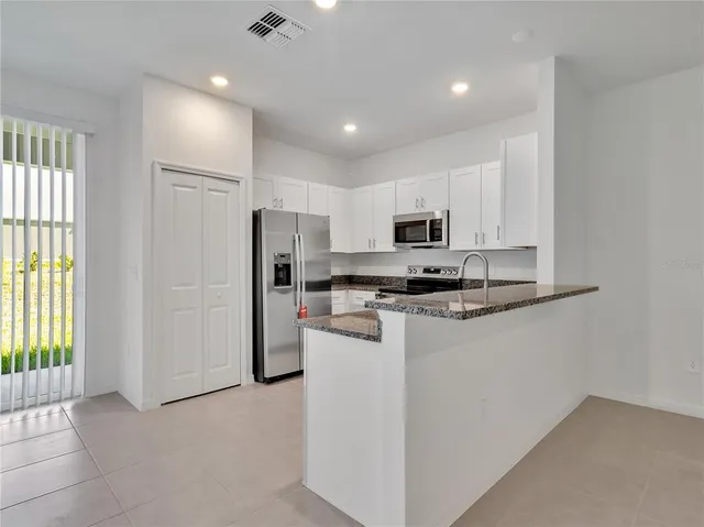 a kitchen with refrigerator cabinets and furniture