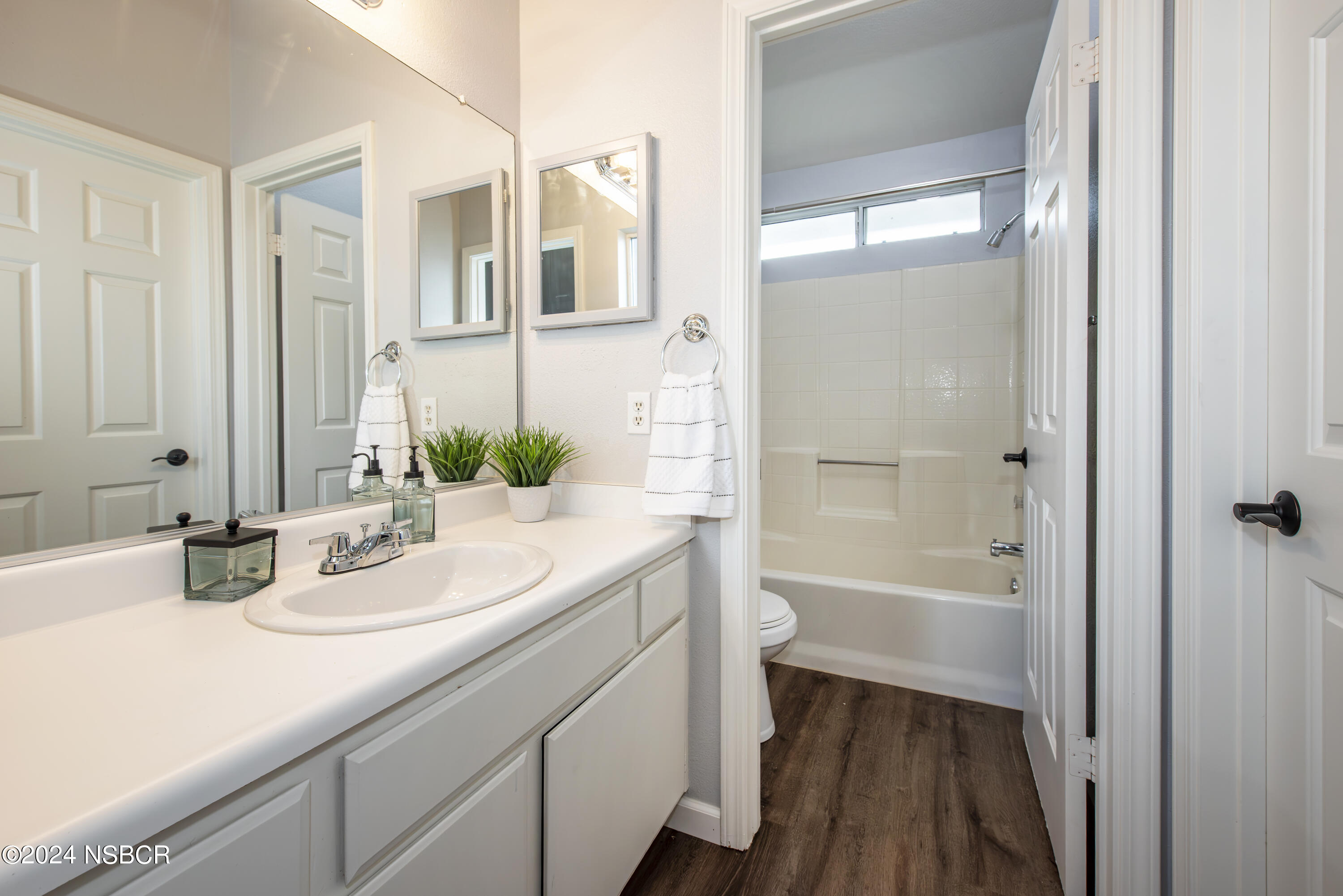 1341 Lloyd Place Lompoc, CA 93436 - Photo 16 of 20 a bathroom with a bathtub a sink and a large mirror