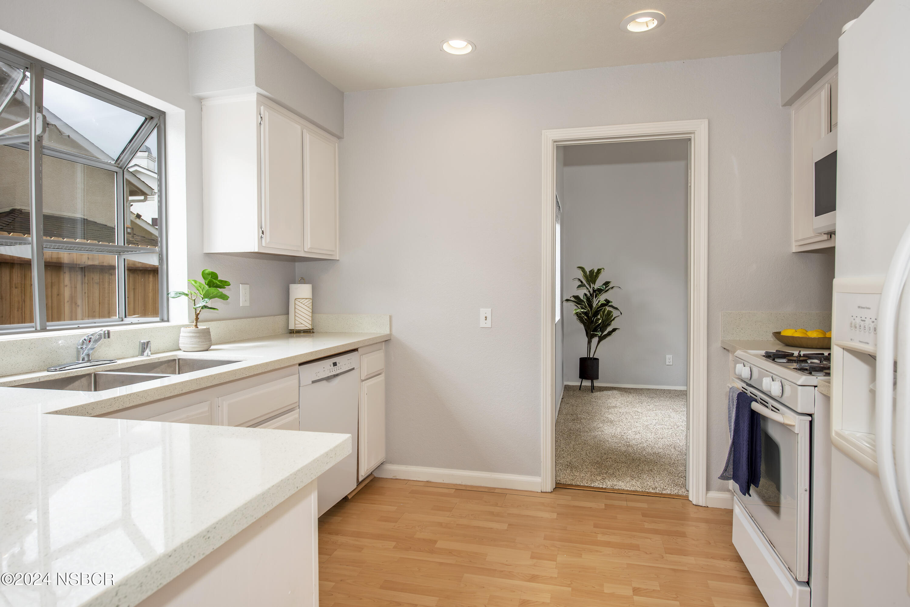 1341 Lloyd Place Lompoc, CA 93436 - Photo 9 of 20 a kitchen with a sink stove and refrigerator