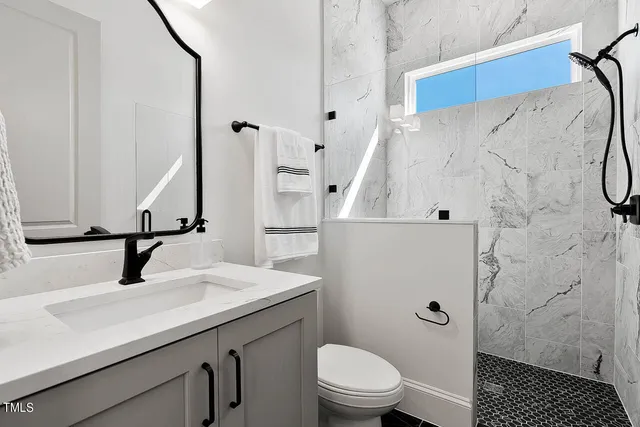 a view of a kitchen with dining area wooden floor electric appliances and a ceiling fan