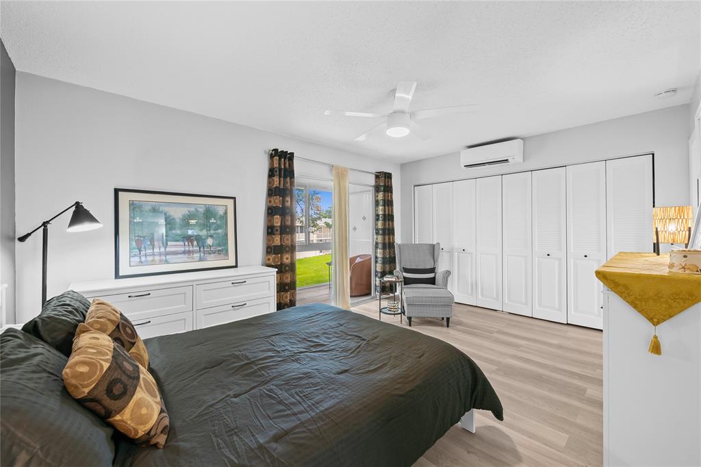 318 Oakridge R, Unit 318 Deerfield Beach, FL 33442 - Photo 14 of 26 a spacious bedroom with a bed and a couch