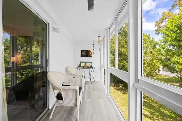 a living room with large windows and wooden floor