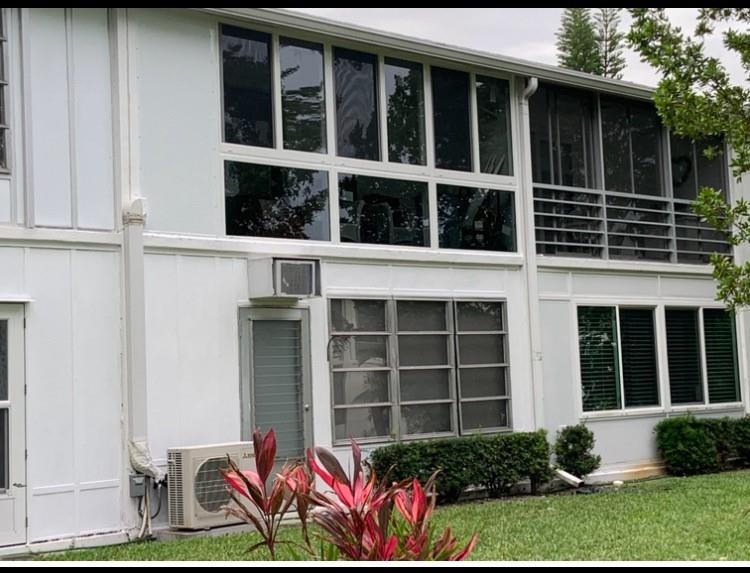 318 Oakridge R, Unit 318 Deerfield Beach, FL 33442 - Photo 21 of 26 a front view of a house with a garden