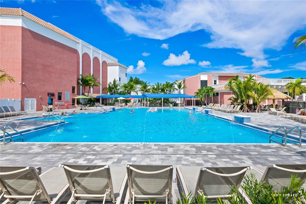 318 Oakridge R, Unit 318 Deerfield Beach, FL 33442 - Photo 25 of 26 a view of an chairs and tables in the patio