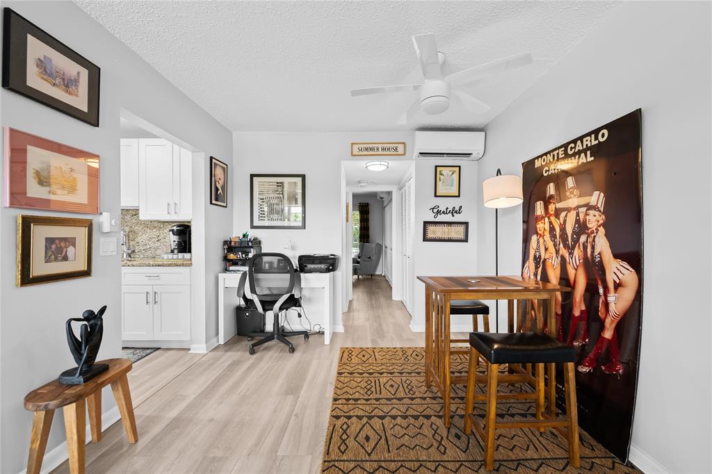 318 Oakridge R, Unit 318 Deerfield Beach, FL 33442 - Photo 6 of 26 a view of a livingroom with furniture and a workspace