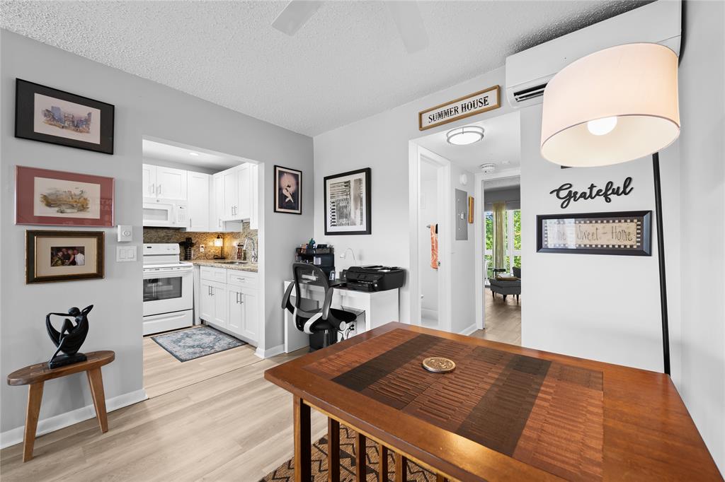 318 Oakridge R, Unit 318 Deerfield Beach, FL 33442 - Photo 7 of 26 a living room with furniture and wooden floor