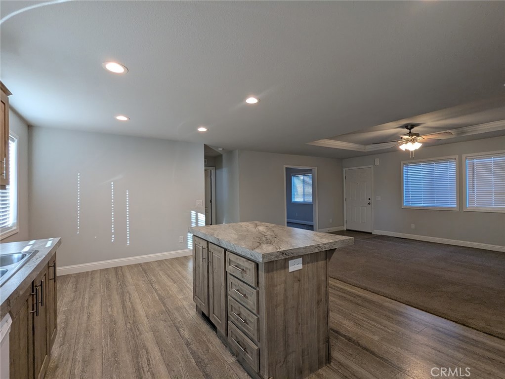 1658 Jaramillo Lane Paradise, CA 95969 - Photo 11 of 54 a kitchen that has a lot of cabinets in it with granite countertop wooden floor