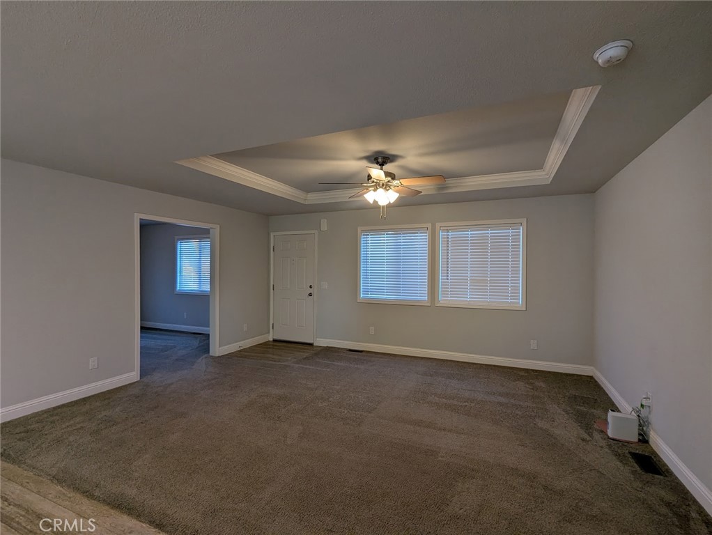 1658 Jaramillo Lane Paradise, CA 95969 - Photo 17 of 54 an empty room with chandelier fan and windows