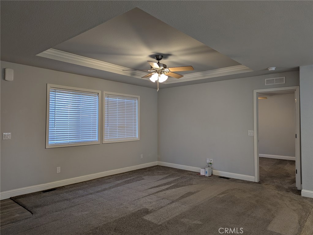 1658 Jaramillo Lane Paradise, CA 95969 - Photo 18 of 54 an empty room with a chandelier fan and windows