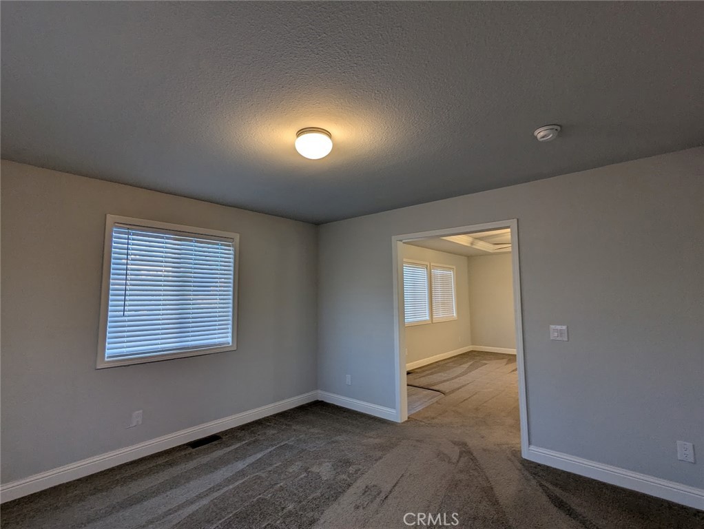 1658 Jaramillo Lane Paradise, CA 95969 - Photo 20 of 54 an empty room with wooden floor and windows