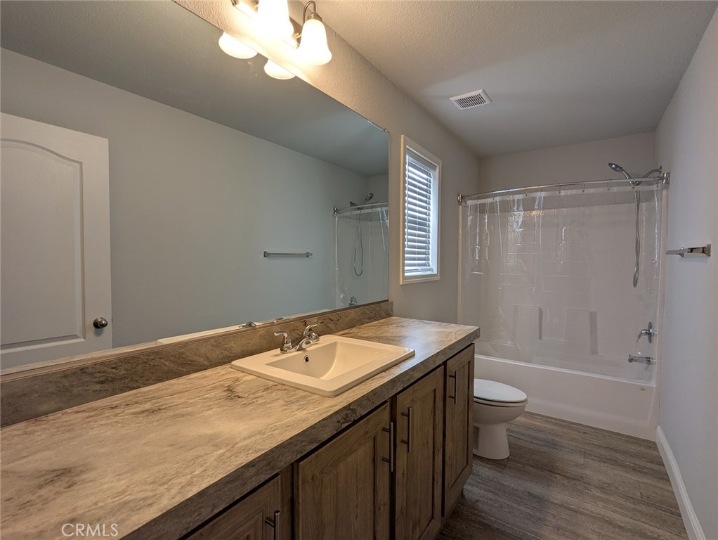 1658 Jaramillo Lane Paradise, CA 95969 - Photo 24 of 54 a bathroom with a granite countertop sink a toilet and shower