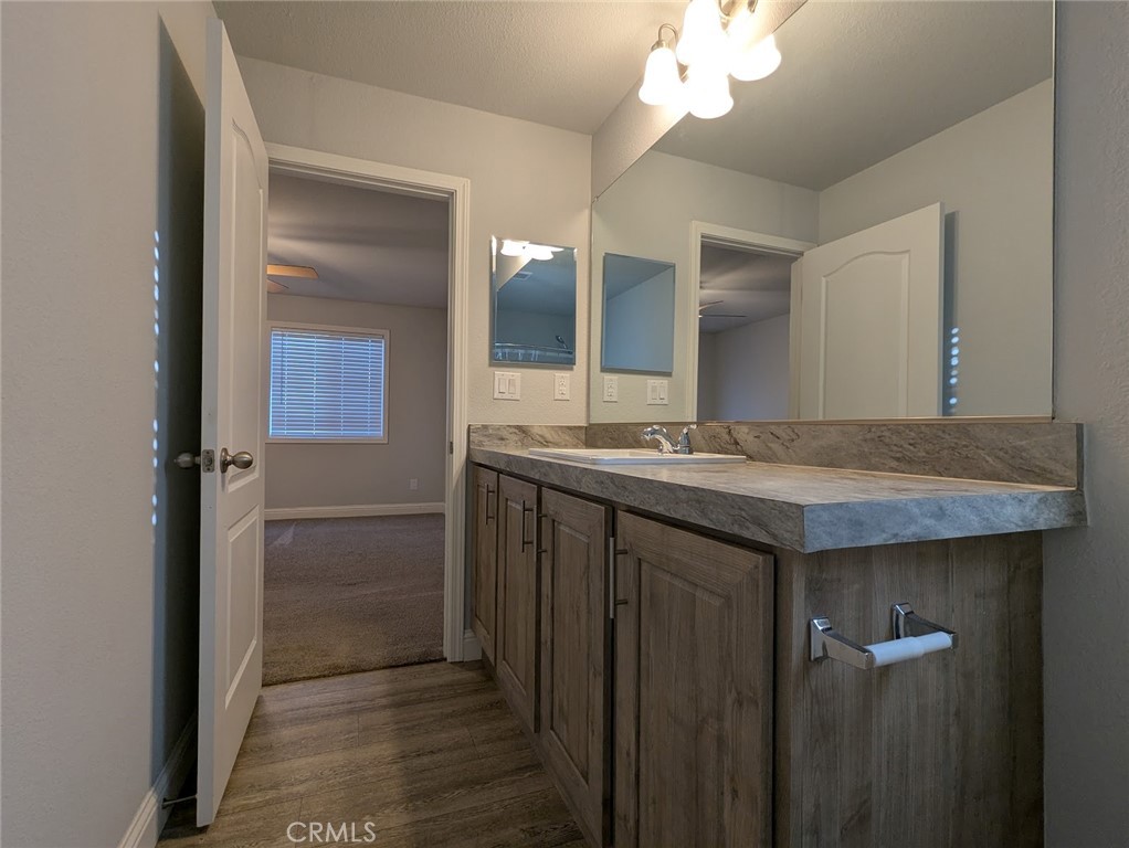 1658 Jaramillo Lane Paradise, CA 95969 - Photo 25 of 54 a bathroom with a granite countertop sink and a mirror