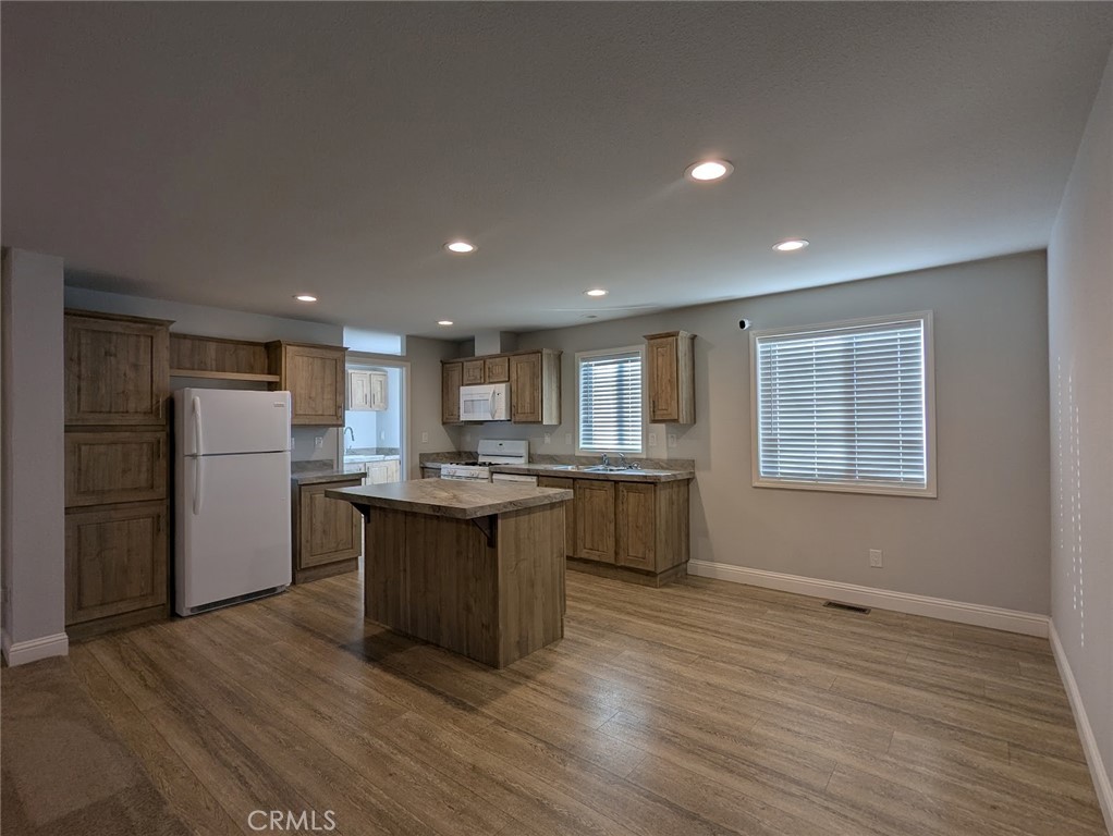 1658 Jaramillo Lane Paradise, CA 95969 - Photo 8 of 54 a kitchen with stainless steel appliances granite countertop a sink dishwasher a refrigerator and a stove with wooden floor
