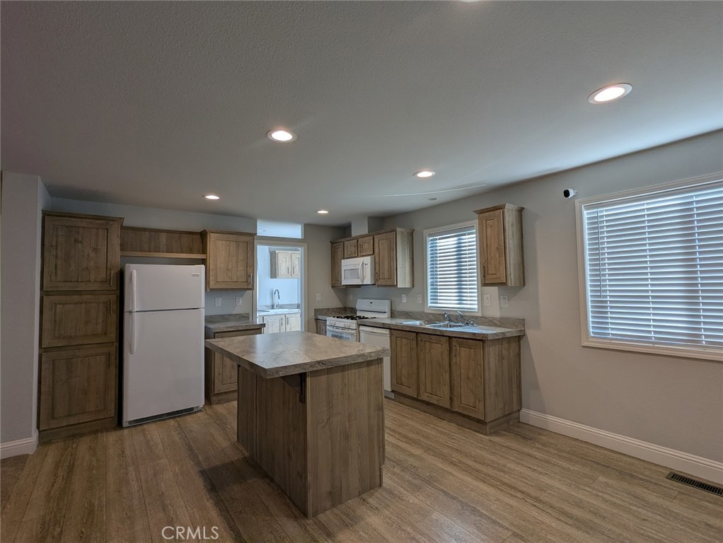 1658 Jaramillo Lane Paradise, CA 95969 - Photo 9 of 54 a kitchen with stainless steel appliances granite countertop a sink stove and refrigerator