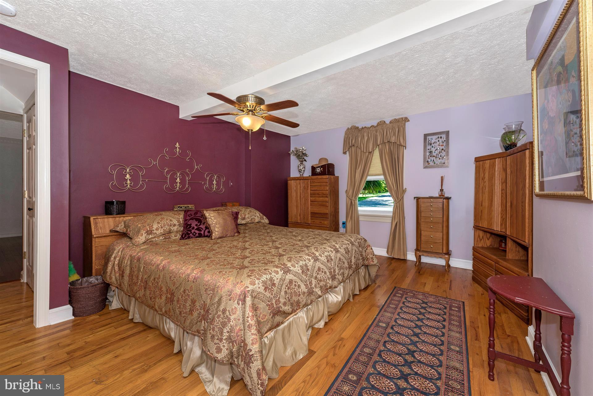 1210 Florence Road Mount Airy, MD 21771 - Photo 12 of 30 a spacious bedroom with a bed and a flat screen tv