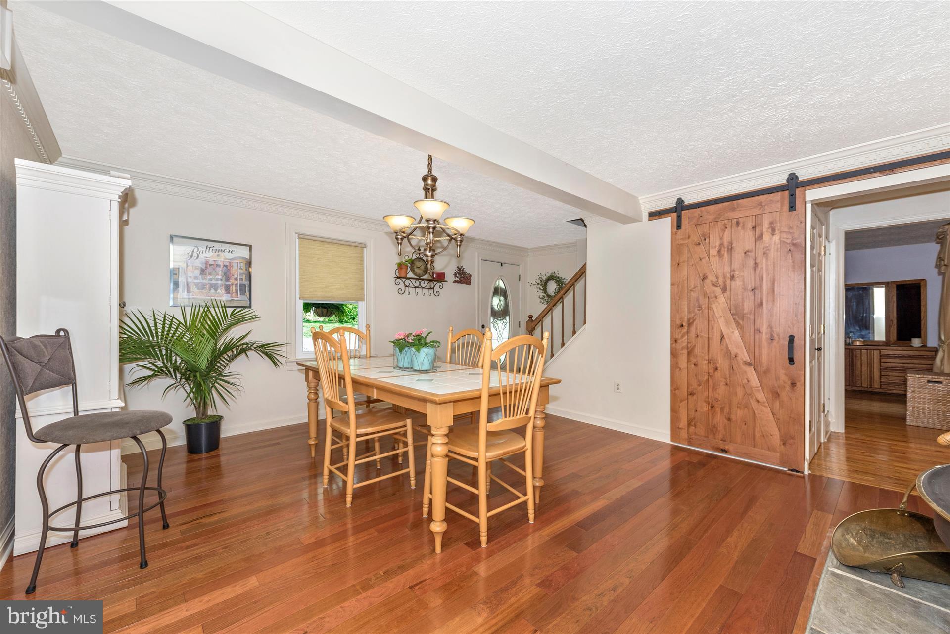 1210 Florence Road Mount Airy, MD 21771 - Photo 10 of 30 a dining room with furniture potted plants and wooden floor
