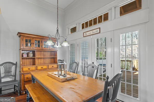 a kitchen with stainless steel appliances granite countertop a stove a sink dishwasher and white cabinets with wooden floor