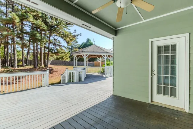 a view of an empty room with a ceiling fan