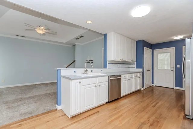 an empty room with windows and fan