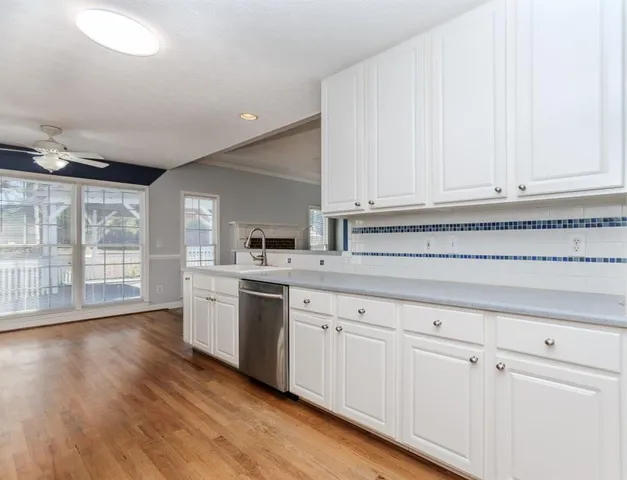 an empty room with fan and entrance