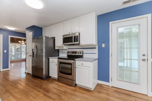 a bathroom with a sink a toilet and a large mirror