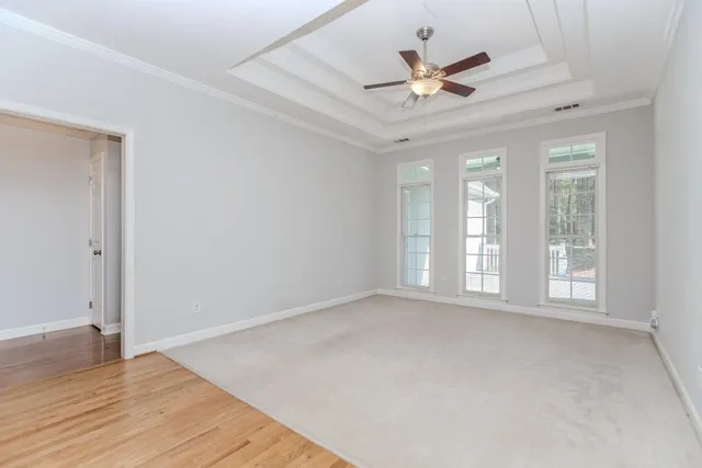 a view of empty room with wooden floor