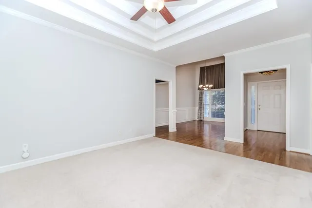 a view of an empty room with a ceiling fan
