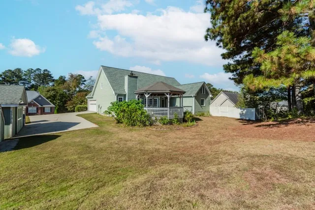 a kitchen with a sink cabinets stainless steel appliances and wooden floor