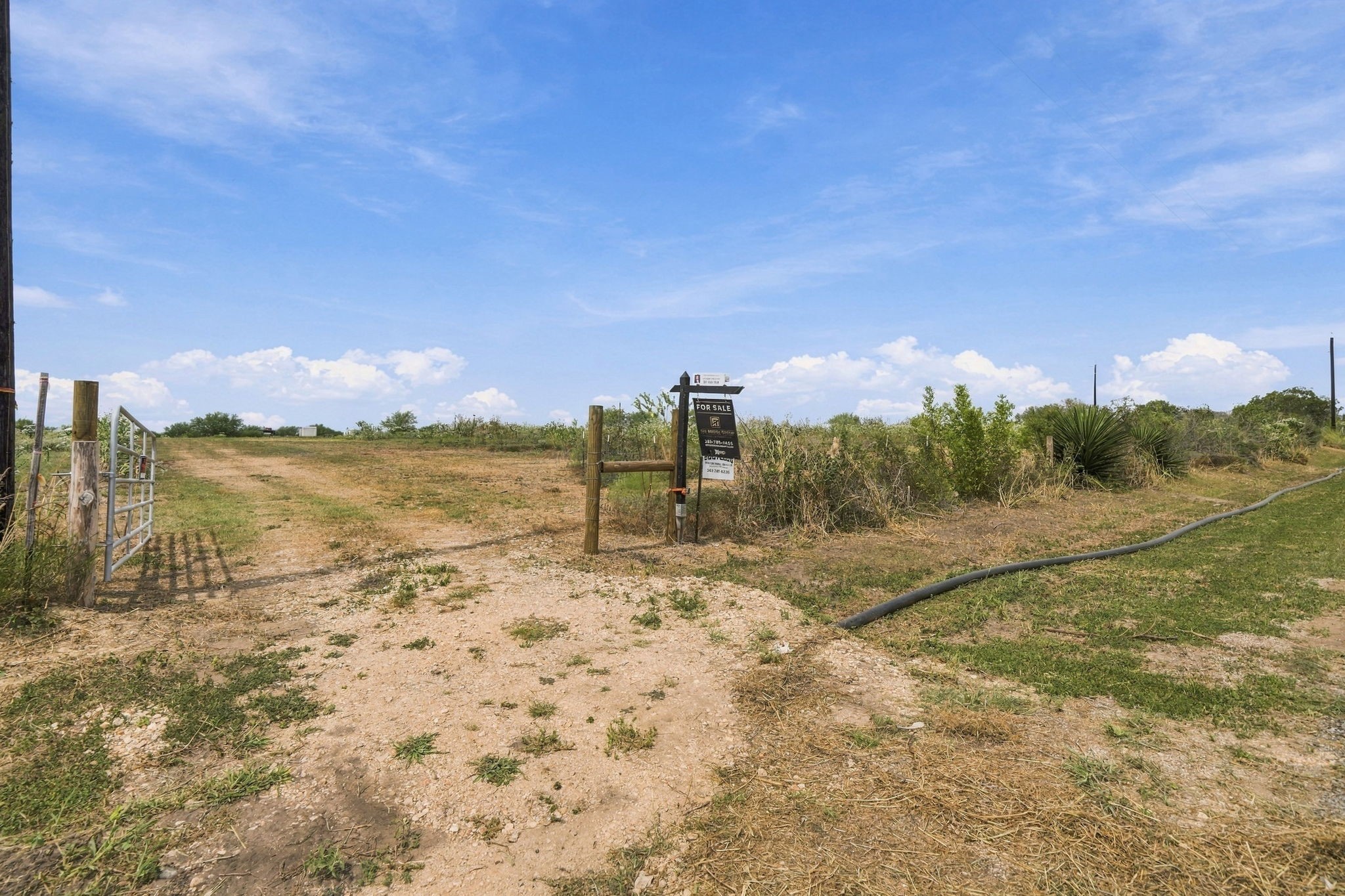 3898 Concrete-Edgar Road Cuero, TX 77954 - Photo 7 of 9 Inviting entrance view showcasing a ready-to-use access point with a metal gate and wooden post boundary structure.