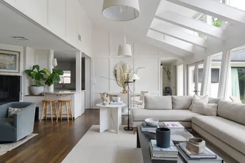 a living room with furniture potted plant and a chandelier