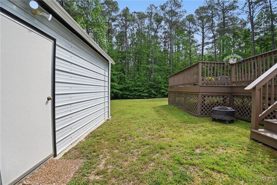 14609 Gatewood Road Dewitt, VA 23840 - Photo 25 of 25 View of grassy yard with a wooden deck and stairwa