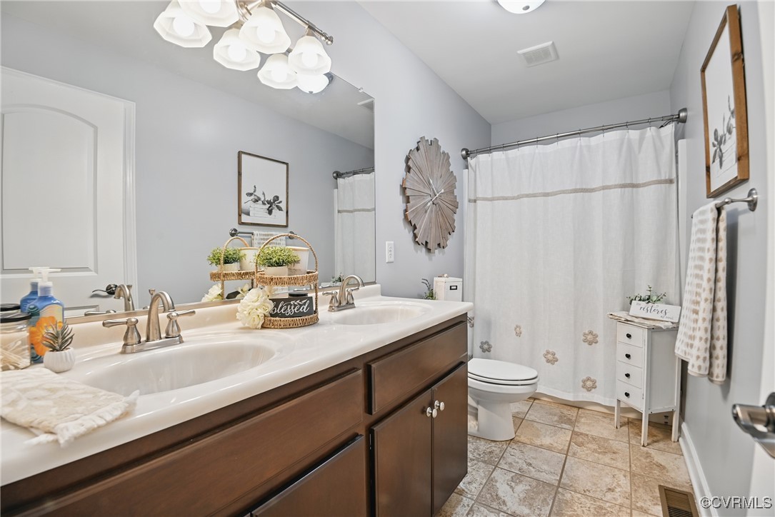 14609 Gatewood Road Dewitt, VA 23840 - Photo 10 of 25 Bathroom with toilet, baseboards, double vanity, s