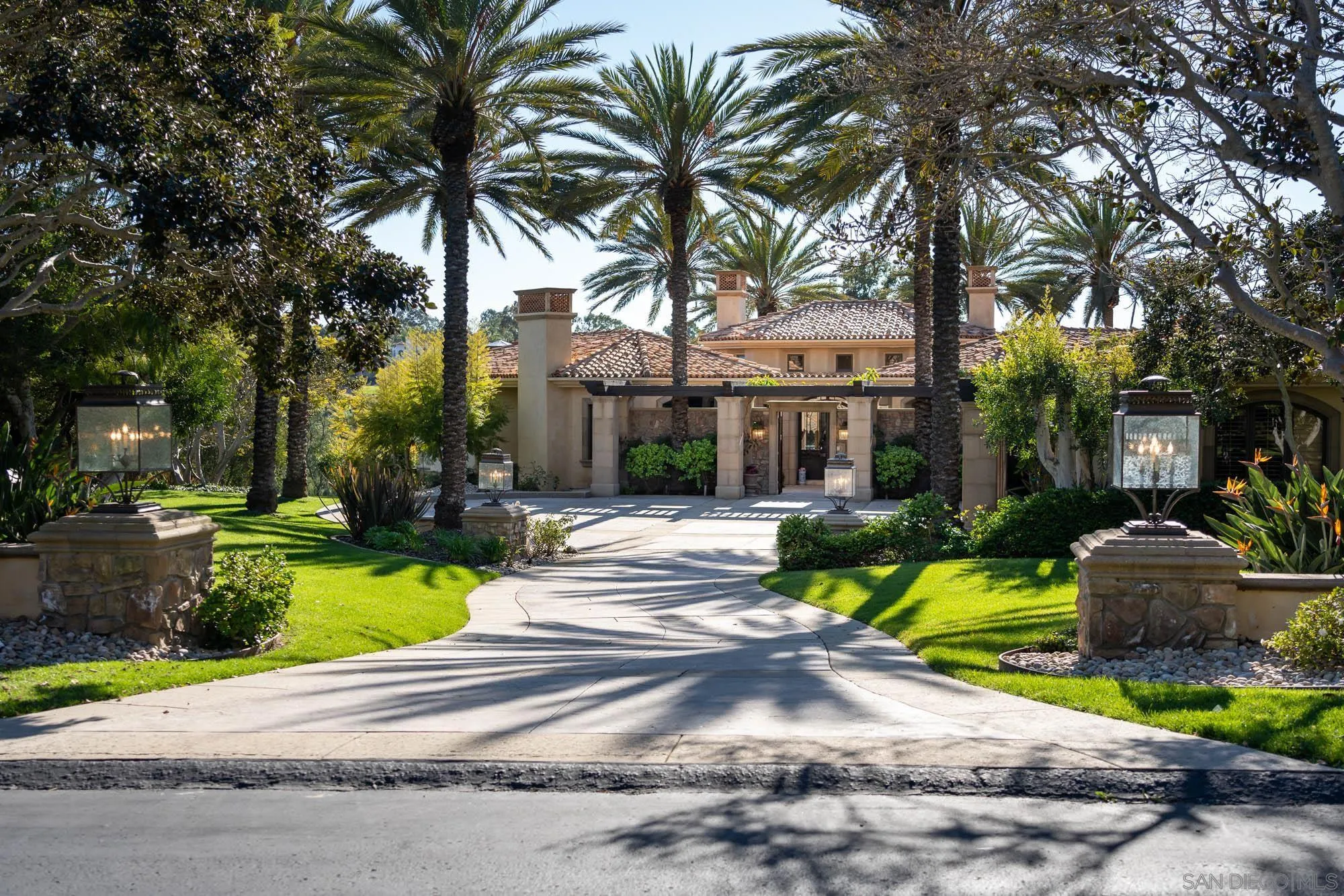 7756 St Andrews Road Rancho Santa Fe, CA 92067 - Photo 43 of 46 a view of a house with a yard and palm trees