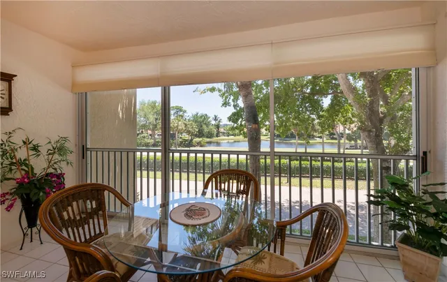 a view of a balcony with chairs and wooden floor