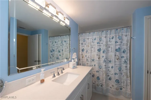 a bathroom with a sink a vanity and a mirror