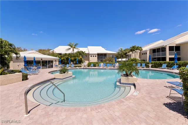 a swimming pool with outdoor seating and yard
