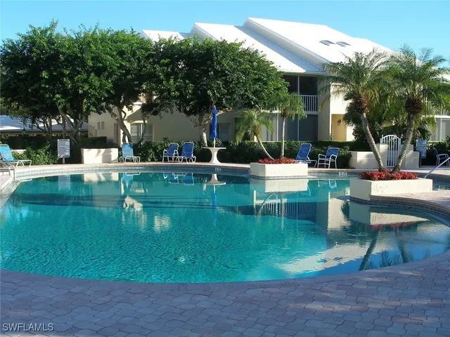 a swimming pool with outdoor seating and yard