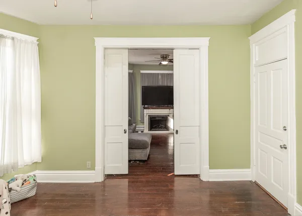 a kitchen with a sink cabinets and wooden floor