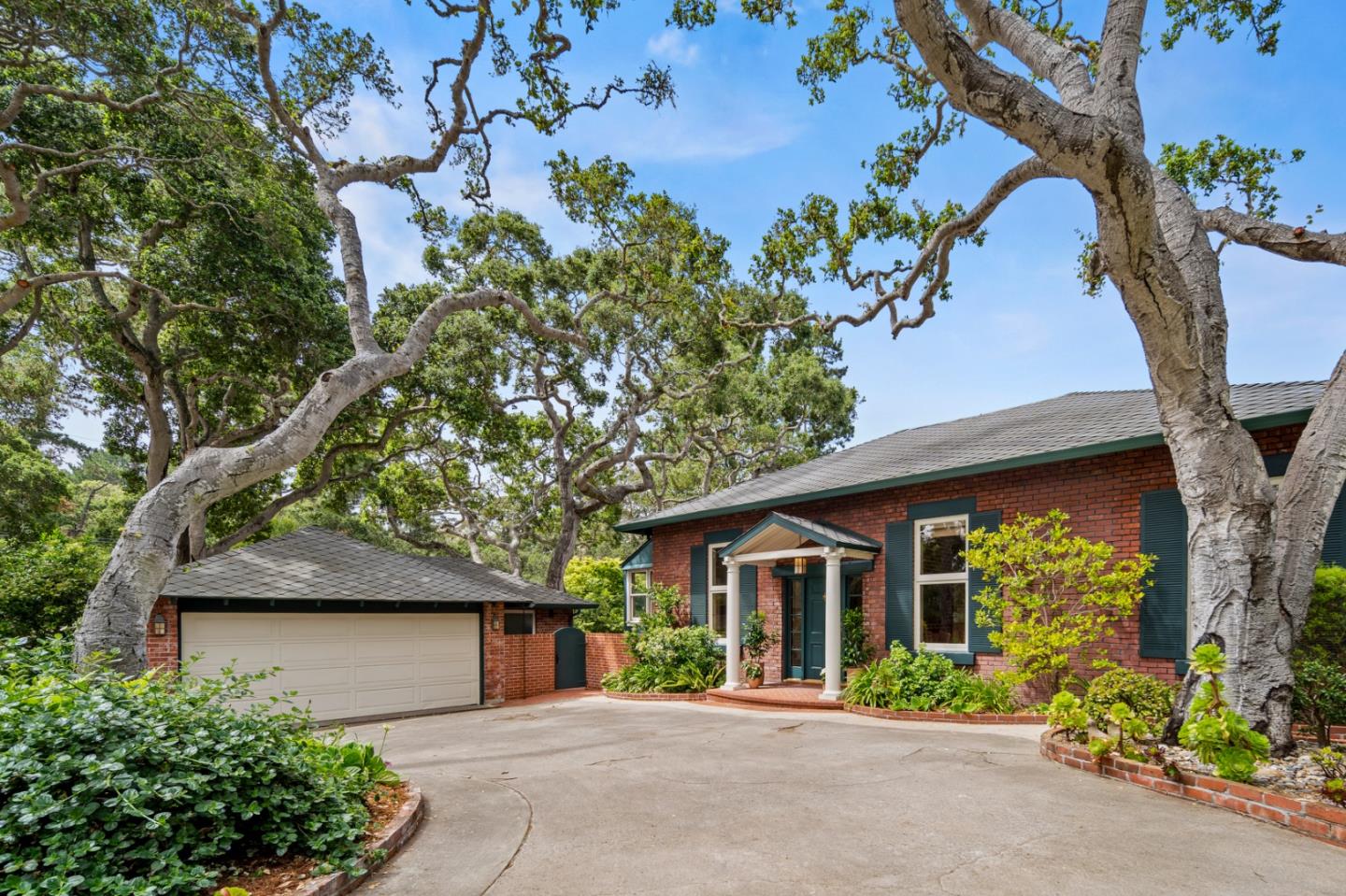 front view of a house with a tree