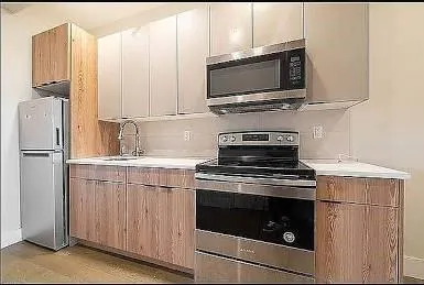 a kitchen with appliances a sink and cabinets
