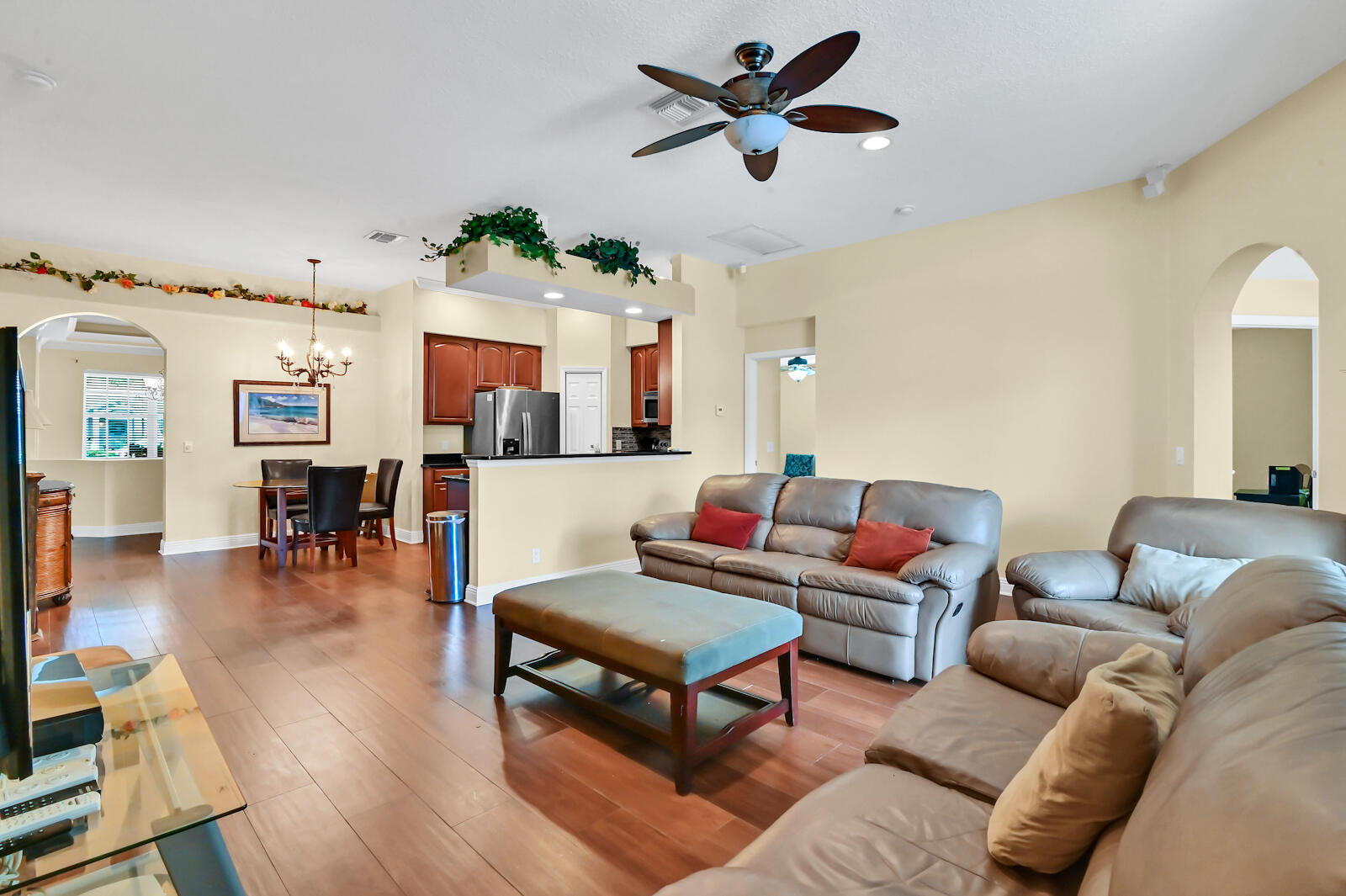 244 Clocktower Drive Jupiter, FL 33458 - Photo 19 of 36 a living room with furniture a fireplace and a chandelier