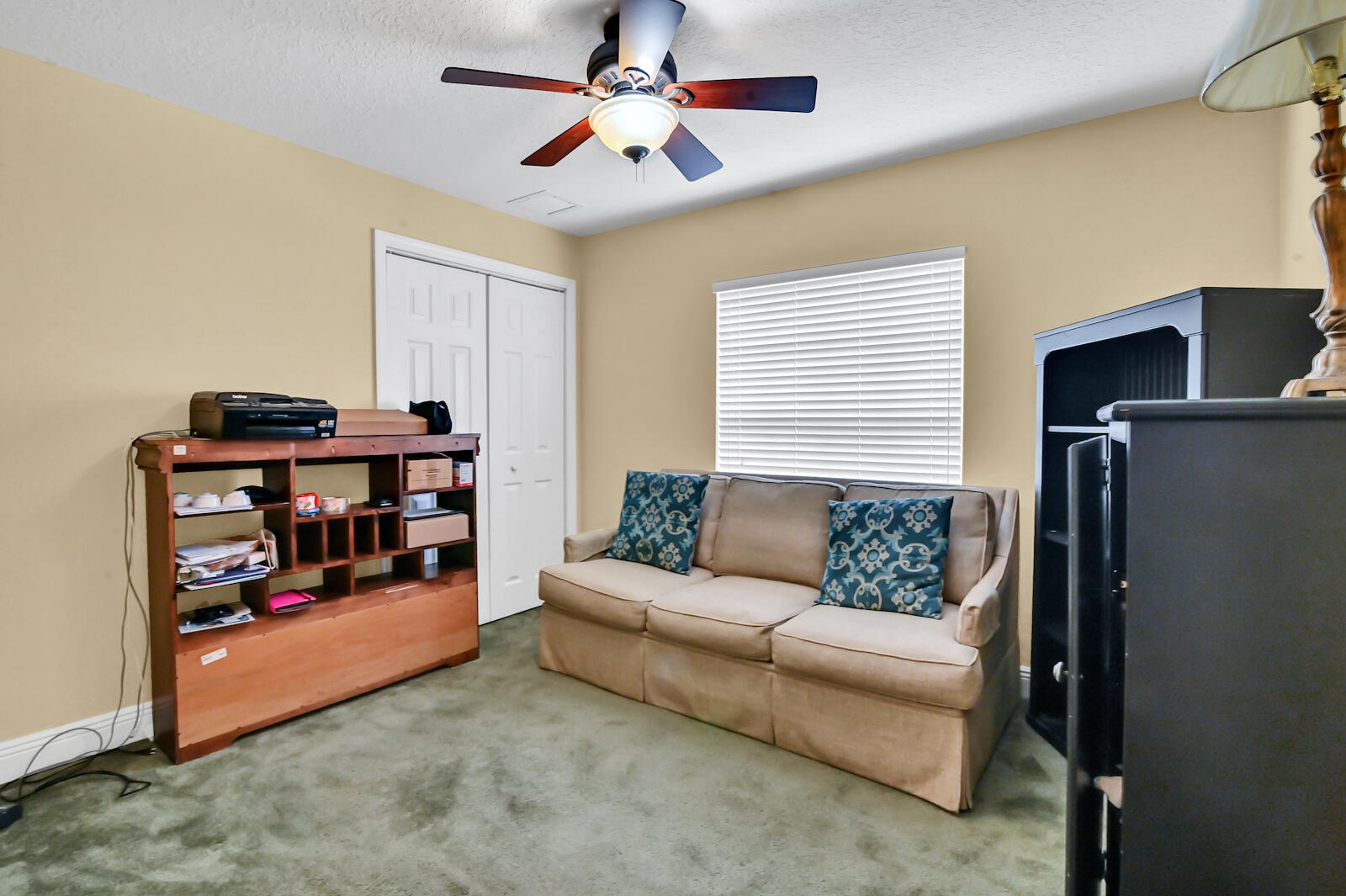 244 Clocktower Drive Jupiter, FL 33458 - Photo 26 of 36 a living room with furniture a ceiling fan and a window