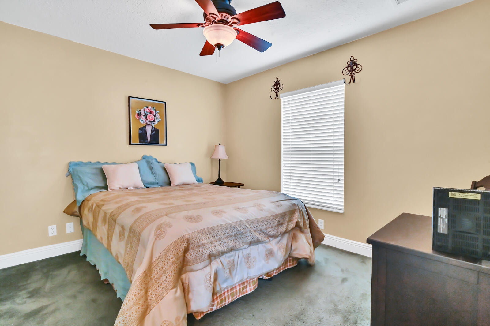 244 Clocktower Drive Jupiter, FL 33458 - Photo 28 of 36 a bedroom with bed and paintings on the wall