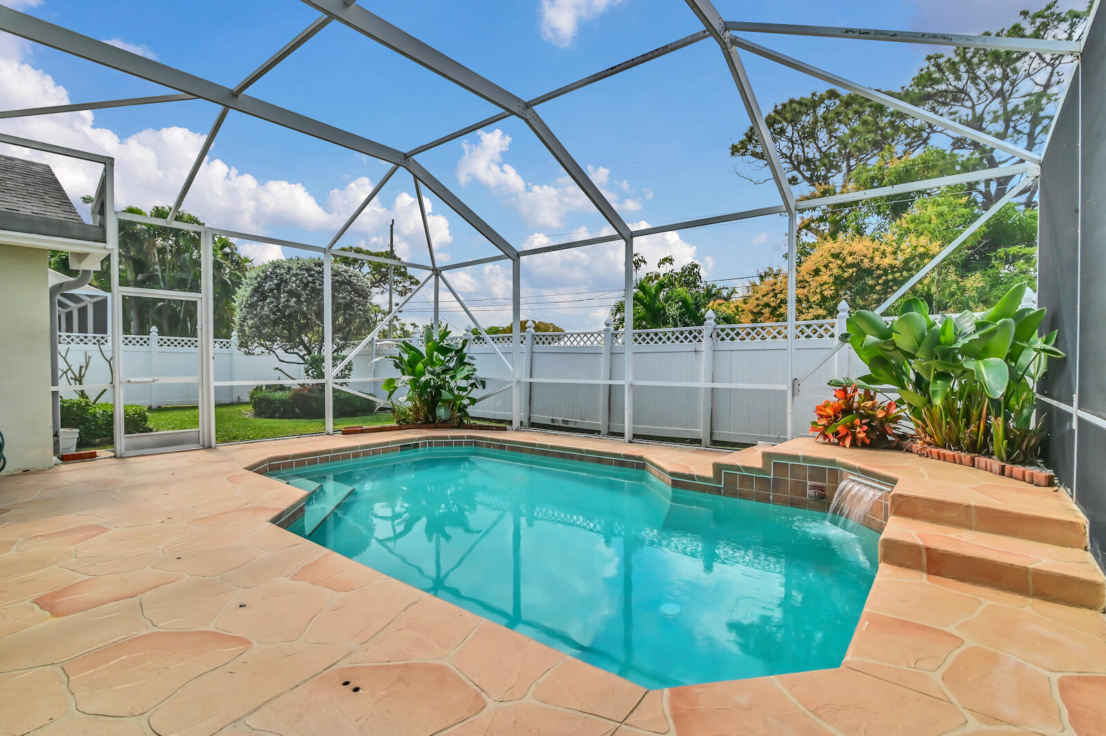 244 Clocktower Drive Jupiter, FL 33458 - Photo 33 of 36 a view of a backyard with a swimming pool