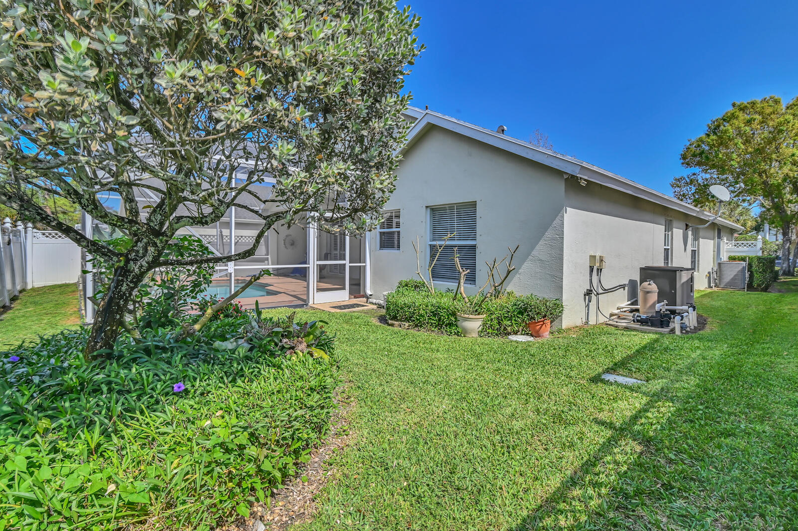 244 Clocktower Drive Jupiter, FL 33458 - Photo 34 of 36 a view of a house with backyard sitting area and garden