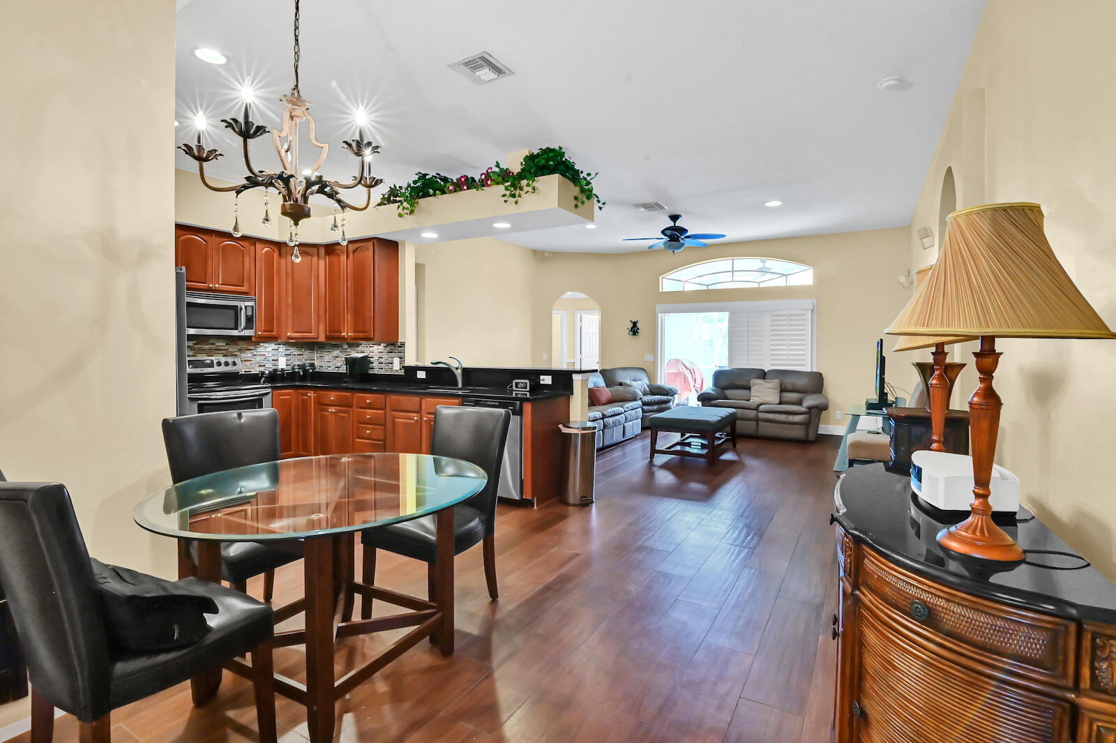 244 Clocktower Drive Jupiter, FL 33458 - Photo 7 of 36 a view of a dining room with furniture and wooden floor
