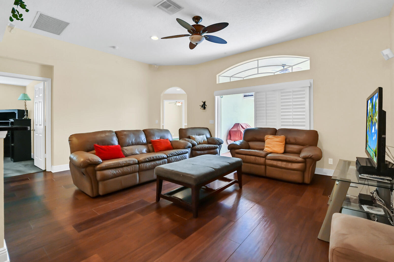 244 Clocktower Drive Jupiter, FL 33458 - Photo 9 of 36 a living room with furniture or wooden floor and a flat screen tv