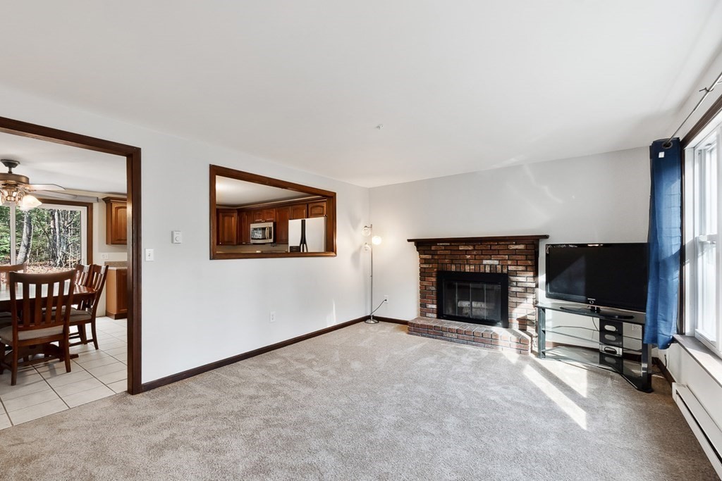 122 Townsend Road Shirley, MA 01464 - Photo 4 of 34 a view of a livingroom with furniture and a fireplace